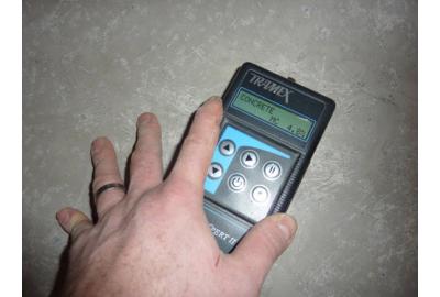 Tramex meter being used to test for moisture in concrete sub floor