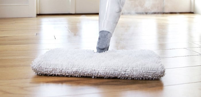 Steam mop cleaning flooring