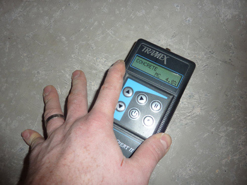 Tramex meter being used to test for moisture in concrete sub floor