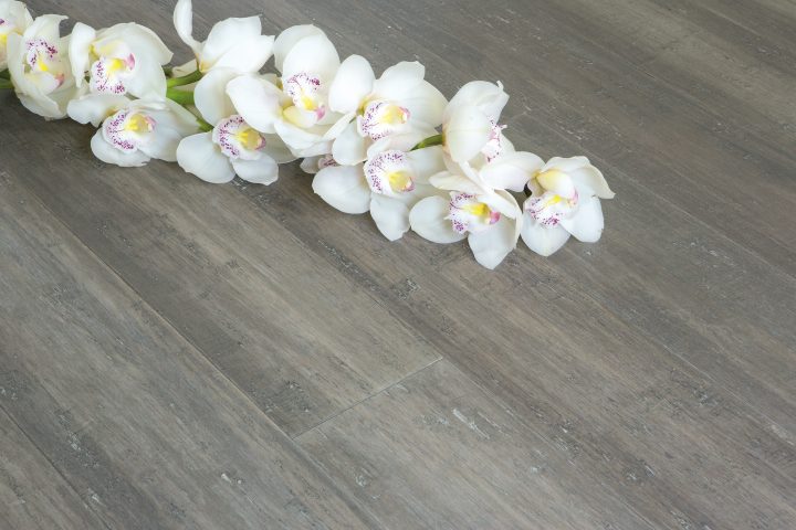 Solid Uniclic Stone Grey Strand Woven 135mm Bamboo Flooring Room Shot with Orchid